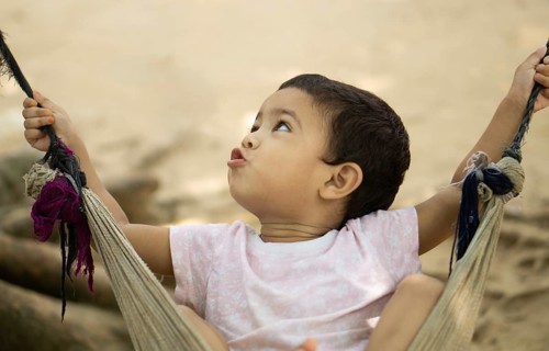 Gazipur, Bangladesh- 22 June 2025: A close up of a child playing on a swing