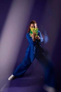 A young woman interacts with a futuristic device, integrating technology and innovation. Her focus