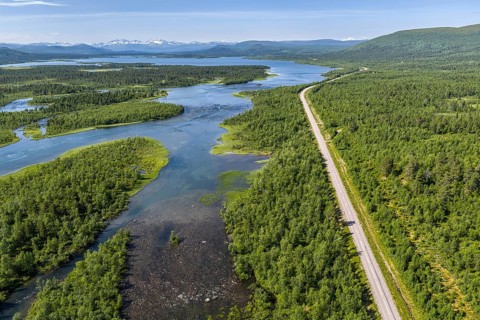 Road along lakes and green forest, road Kiruna to Nikkaluokta, aerial view, Sweden
