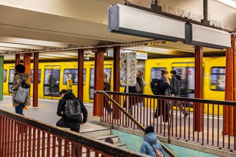 Alexanderplatz railway station in Berlin. People on a train platform with subway. Berlin, Germany