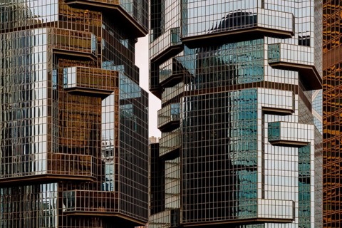 Cropped view of contemporary glass and steel buildings reflecting sunlight in the bustling city of