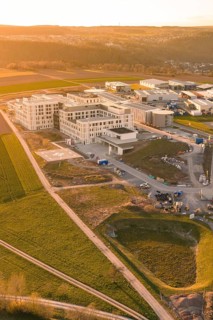 Modern buildings in a scenic setting at sunset, with focus on construction, new hospital at the