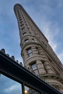 From below image captures the stunning architecture of the Flatiron Building in Manhattan,