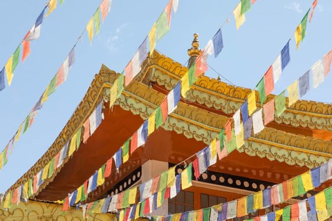 Vibrant prayer flags flutter around the ancient Gompa Soma in Leh, Ladakh, India. Nestled in the