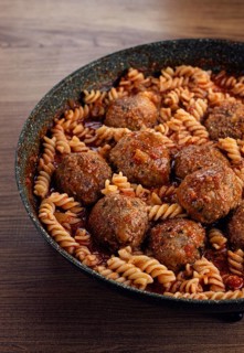 Minced meat meatballs, in tomato sauce, with fusilli pasta, in a cast-iron pan, homemade, no people