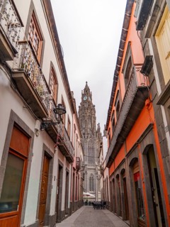 A charming view down a narrow street flanked by traditional buildings leading towards the intricate