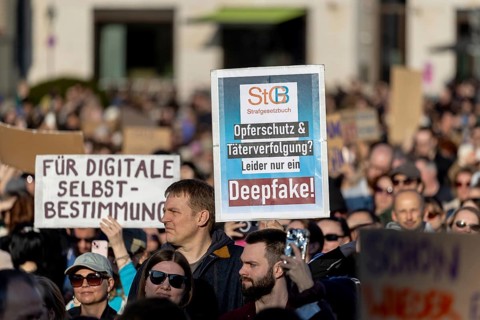 Berlin, Germany - 22.3.2026: Demonstrators, including one holding up a poster with the inscription:
