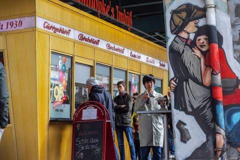 Cult in Berlin: Currywurst at Konnopke's Imbiss. Kiosk with neon sign and logo. Berlin, Germany