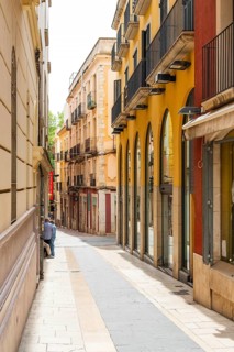 Narrow streets with shops in the city centre of Figueras, Spain