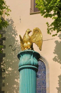 Fountain in front of the Protestant town church, green fountain with golden bird, detail, bird
