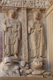 Biblical stone sculptures of the Apostles Peter and John at the entrance, reliefs, stone carving,