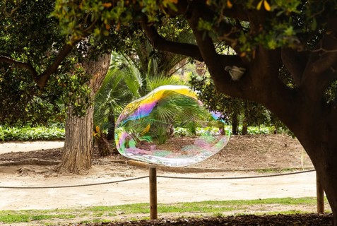 Large soap bubble in a park in Barcelona, Spain