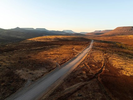Aerial view, road leading through dry desert landscape, hills in Damaraland, Namibia