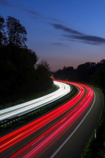 Long exposure of a motorway at night with red and white light trails of cars, Winnenden,
