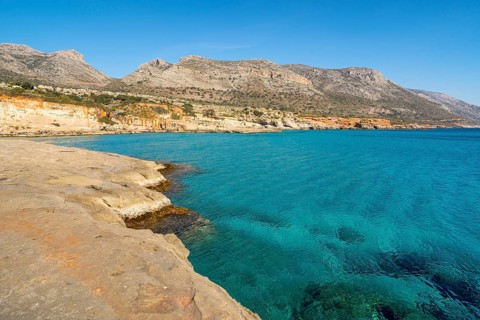 Breathtaking view of Greece's coastline featuring vibrant turquoise waters and rocky shores under a