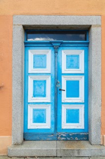 Historic wooden door in blue and white on the market square in Weißenberg, Saxony, Germany