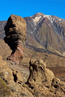 Roques de Garcia, volcanic rock formations under sunny sky in front of a mountain range, Teide,