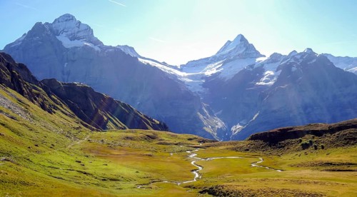 A stunning panoramic view of the french alps and swiss alps showcasing lush green landscapes and a