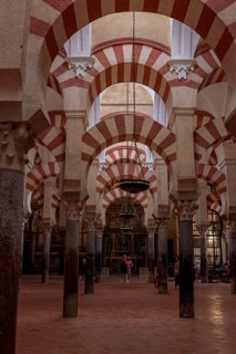Arches and columns in a spacious interior with dominant red and white colours, Cathedral Mosque of