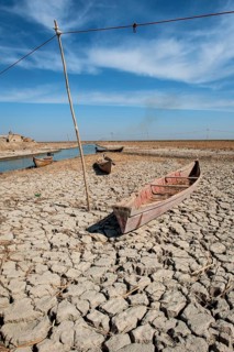 Traditional Iraqi marsh dwellers canoe abandoned on the dry cracked earth of the central marshes of