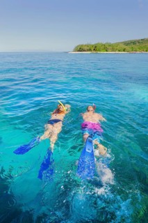Couple snorkelling in Fiji Islands clear water, Drawaqa Island, Yasawa island group, Fiji