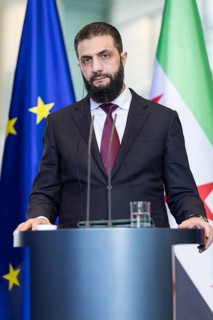 Ahmed al-Sharaa (President of the Syrian Arab Republic) at a joint press conference with Friedrich