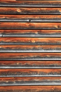 Facade cladding with wood, boards, partly already weathered