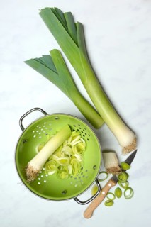 Leek, leek sticks and leek rings in a sieve bowl