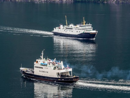 Traditional small ferries meet at Hellesylt harbour, ferry Hellesylt - Geiranger, Hellesylt, Norway