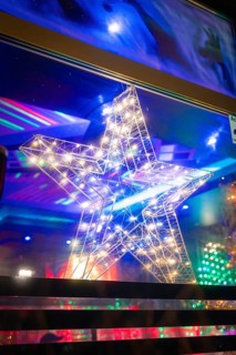 Shining star in a window with colourful lights in the background, Christmas market, Nagold, Black