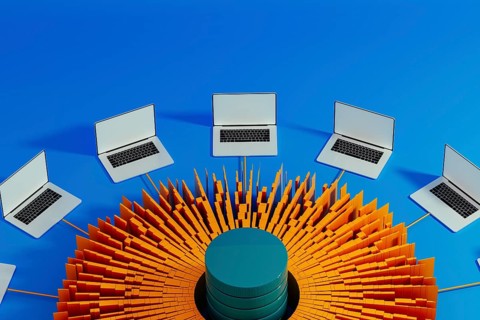 Multiple laptops surround a central data hub, showcasing technology integration for artificial