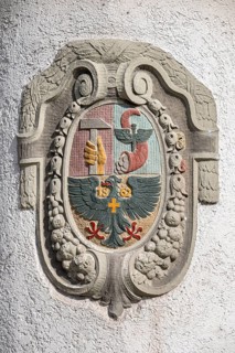 Historical coat of arms carved out of stone, stonemasonry on the façade of the Count's House in the