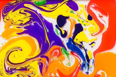 A vivid mixture of swirling colors including orange, yellow, purple, and blue creates a dynamic and