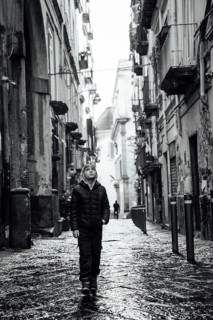 Young boy in a narrow street of Naples, Italy