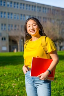 Vertical portrait of an asian student in the campus of the university