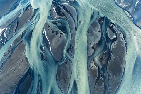 Stunning aerial drone image capturing the intricate patterns and vivid colors of river deltas along