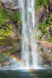 Rainbow over waterfall, Milford Sound, Fiordland National Park, South Island, Southland, New