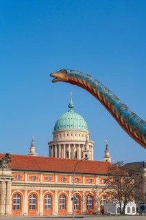 Large figure of a brontosaurus from a dinosaur exhibition in front of the film museum in the