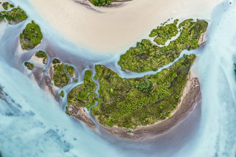Aerial view over the branches of river Rio Ibanez, wide river landscape, muddy and blue glacial