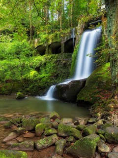Waterfall at the historic Niezelgrund hydroelectric power station, Lohmen, Saxony, Germany