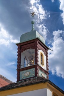Town house from 1722 with tower pavilion with Madonna figure in lantern, landmark of the