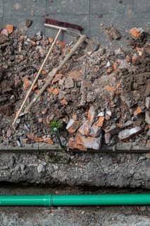 Newly laid green sewage pipe, trench, excavation, broom and pickaxe, Stuttgart, Baden-Württemberg