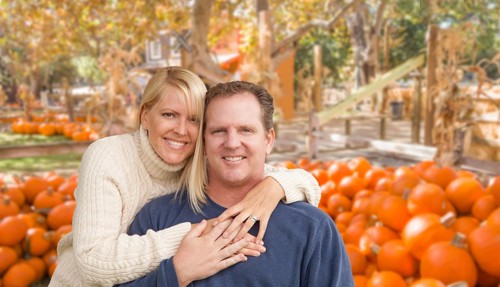 Happy Caucasian Young Adult Couple at the Pumpkin Patch Farm