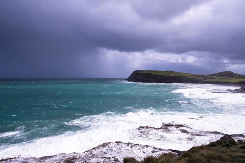 New Zealand, South Island of New Zealand, blue sea, ocean coast, dark sky, ominous sky, sea spray