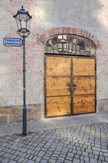 Street lamp and wooden gate, street name, brick building, Kornmarkt, Quedlinburg, Harz,