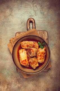 Stuffed cabbage rolls with minced meat, in tomato sauce, top view, without people, in the spotlight