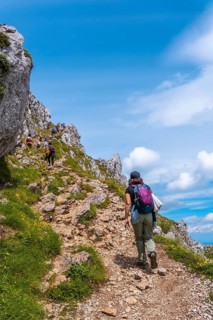 Mount Aizkorri 1523 meters, the highest in Guipuzcoa. Basque Country. A young woman reaching the