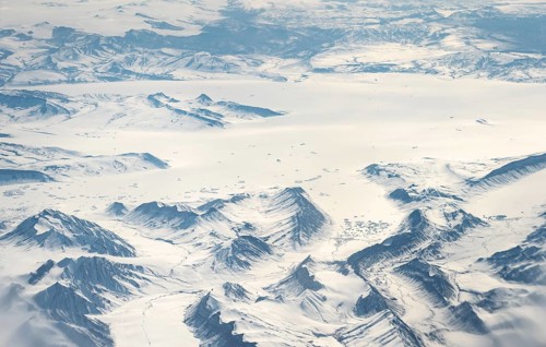 Icy, snowy arctic mountain landscape with glaciers, aerial view, Greenland, Arctic