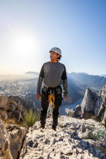 A man enjoys a moment of rest after practicing mountaineering and rappelling in the scenic Eagle's