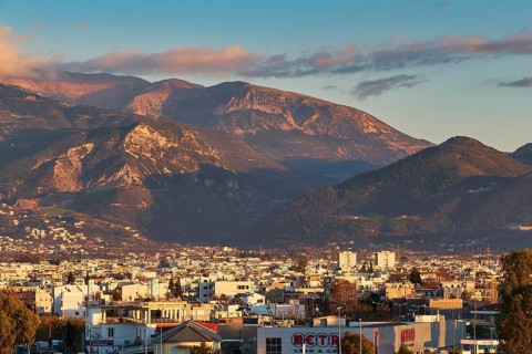 City view at sunset with mountains in background and cloudy sky, Patras, Peloponnese, Greece